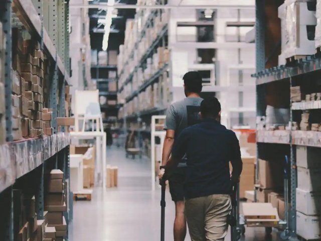 two-people-walking-through-a-warehouse - moter