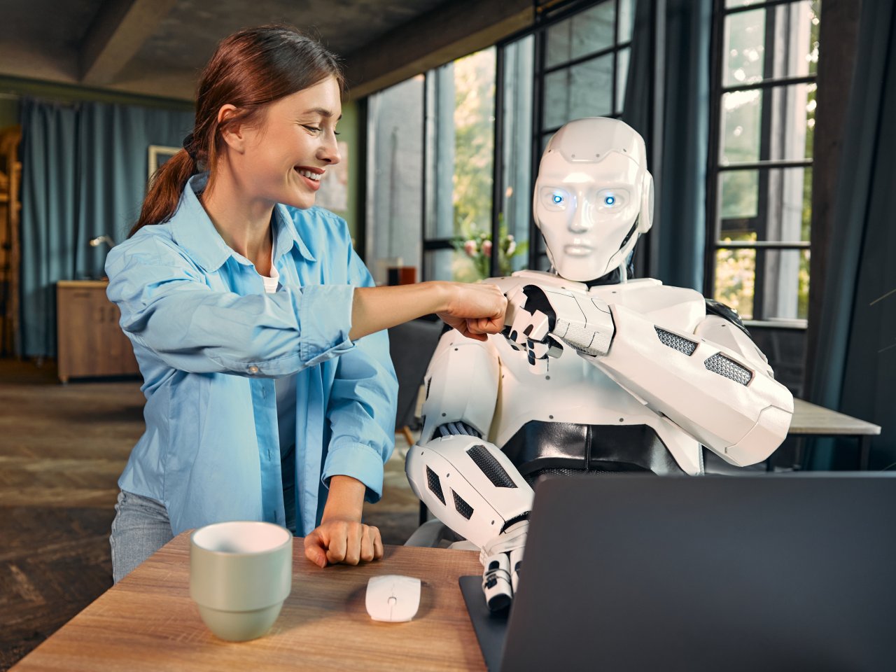 robot-and-woman-working-on-laptop-in-office-2023-11-27-05-32-05-utc